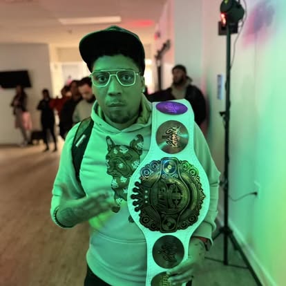 DJ Endy holding championship belt